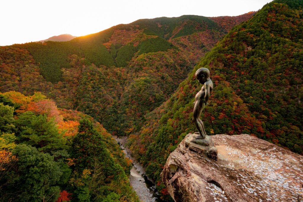 รูปปั้น The Peeing Boy of Iya Gorge และหุบเขาอิยะในฤดูใบไม้ร่วง
