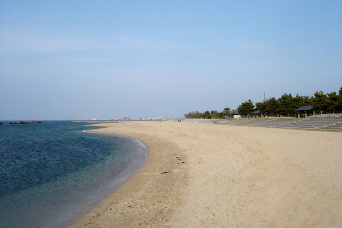 หาดทรายยาวของหาดพิจิพิจิบีช เมืองฮันนัน โอซาก้า มีคนเล่นน้ำและเล่นวอลเลย์บอลชายหาด